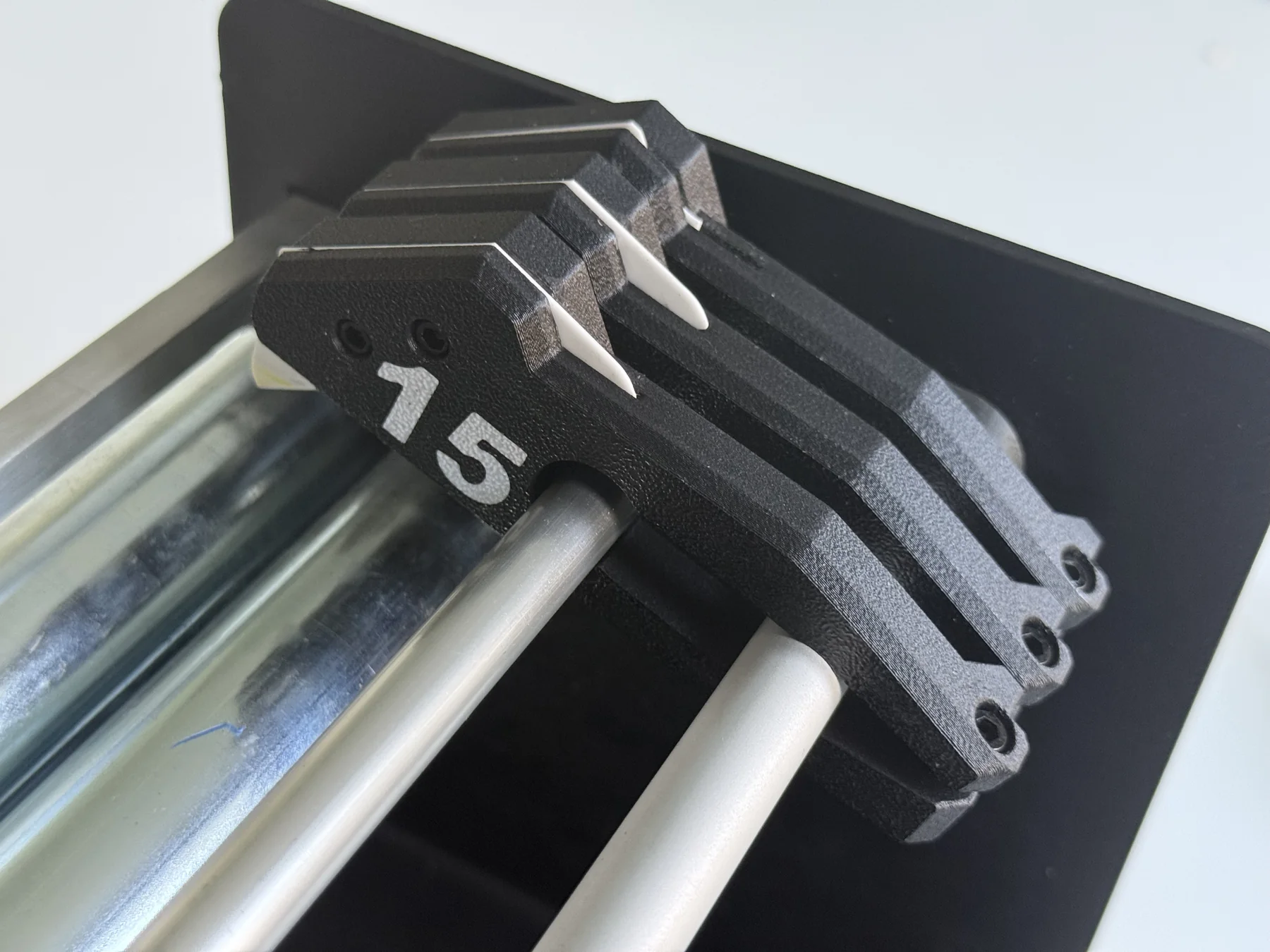 PA6-CF functional parts fitted onto metal rods